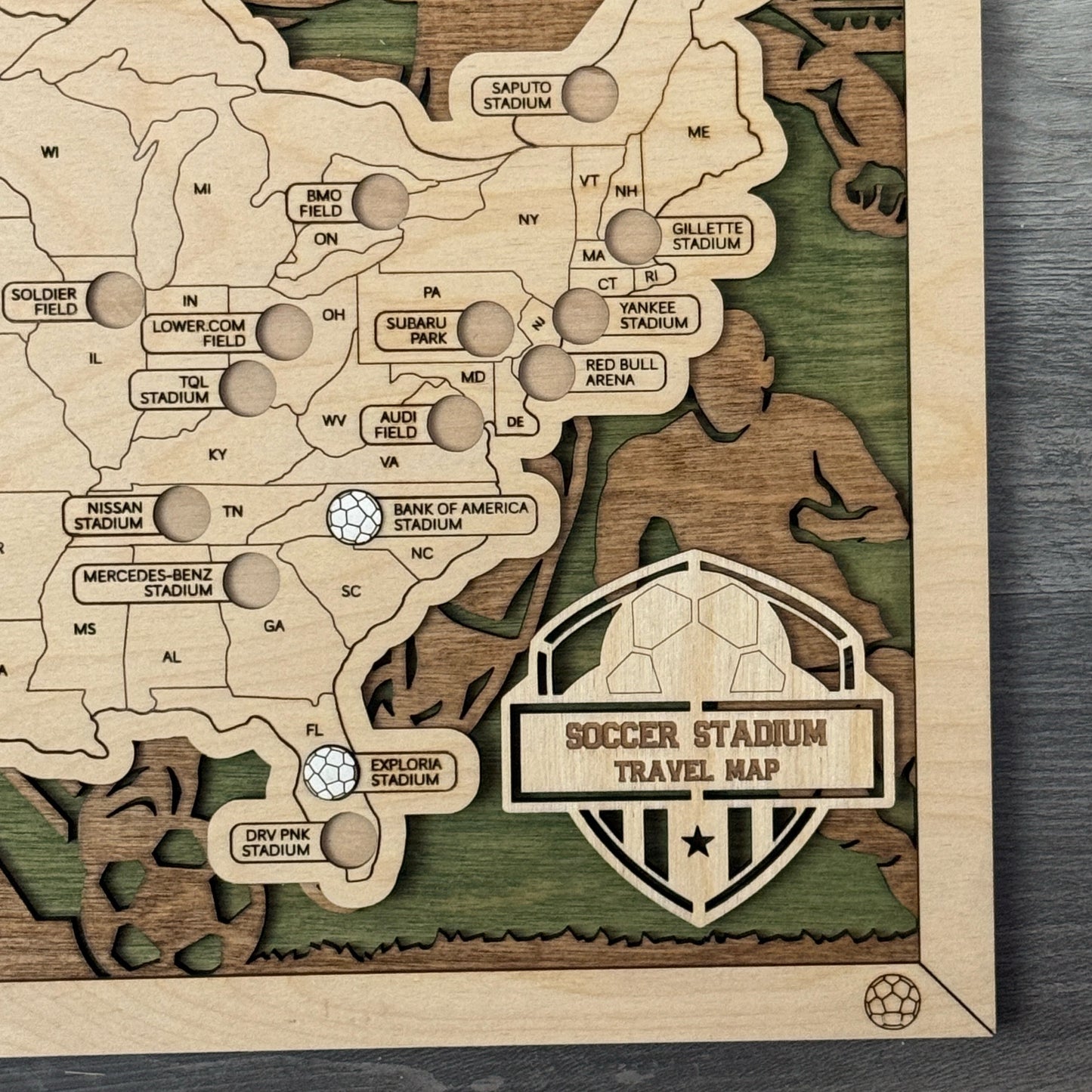 Wooden map of a soccer stadium with detailed design on a wooden surface
